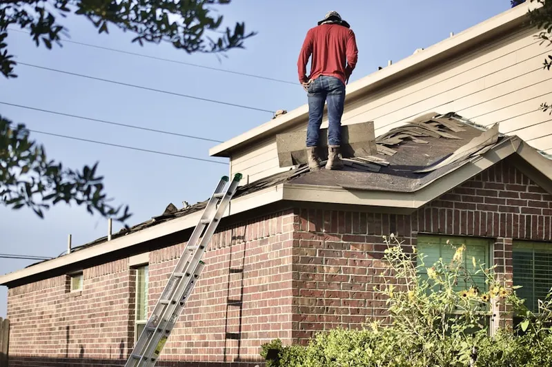 Professional roofer working on a residential roof in Poquonock